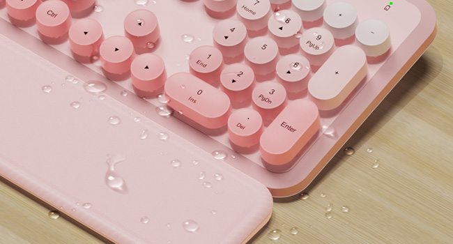 Water droplets on wireless keyboard and wrist rest showing splash resistant design easy wipe clean