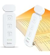 White electronic device with three buttons and LED indicators. Rectangular shape with rounded edges. Shown clipped to book pages, suggesting use as a reading light or bookmark.