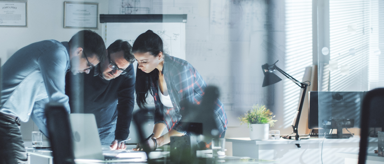 two people looking at a tablet in a modern office