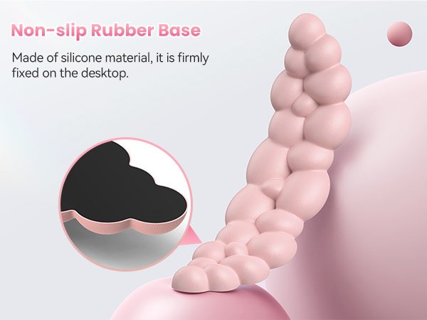 Pink bubble-shaped silicone object with non-slip rubber base. Close-up shows black bottom layer. Text indicates it's made of silicone and firmly fixed on desktop.