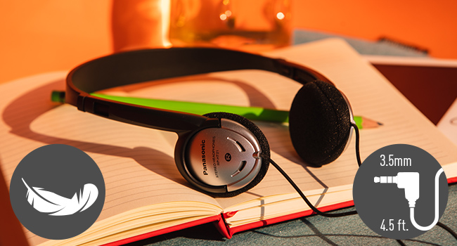 Panasonic RP-HT21 over-ear corded headphone sitting on a notebook with pencil.