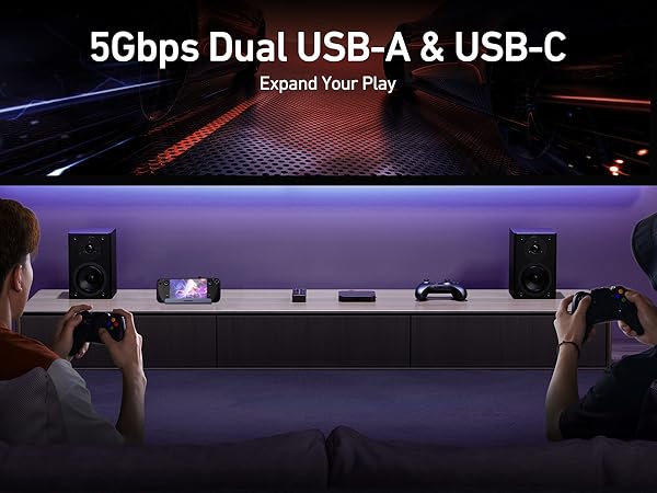 Text reads '5Gbps Dual USB-A &amp; USB-C'. Dark gaming setup with purple LED lighting showing multiple monitors and gaming peripherals.