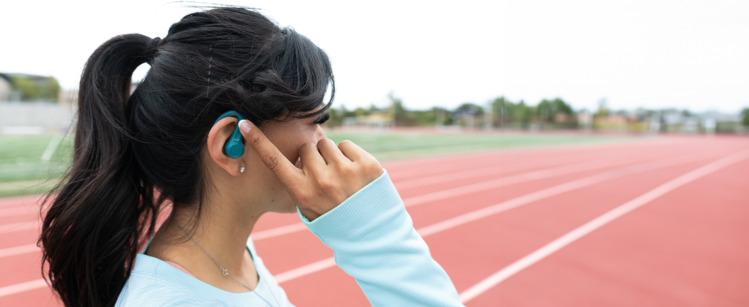 Woman using touch controls on jbuds sport