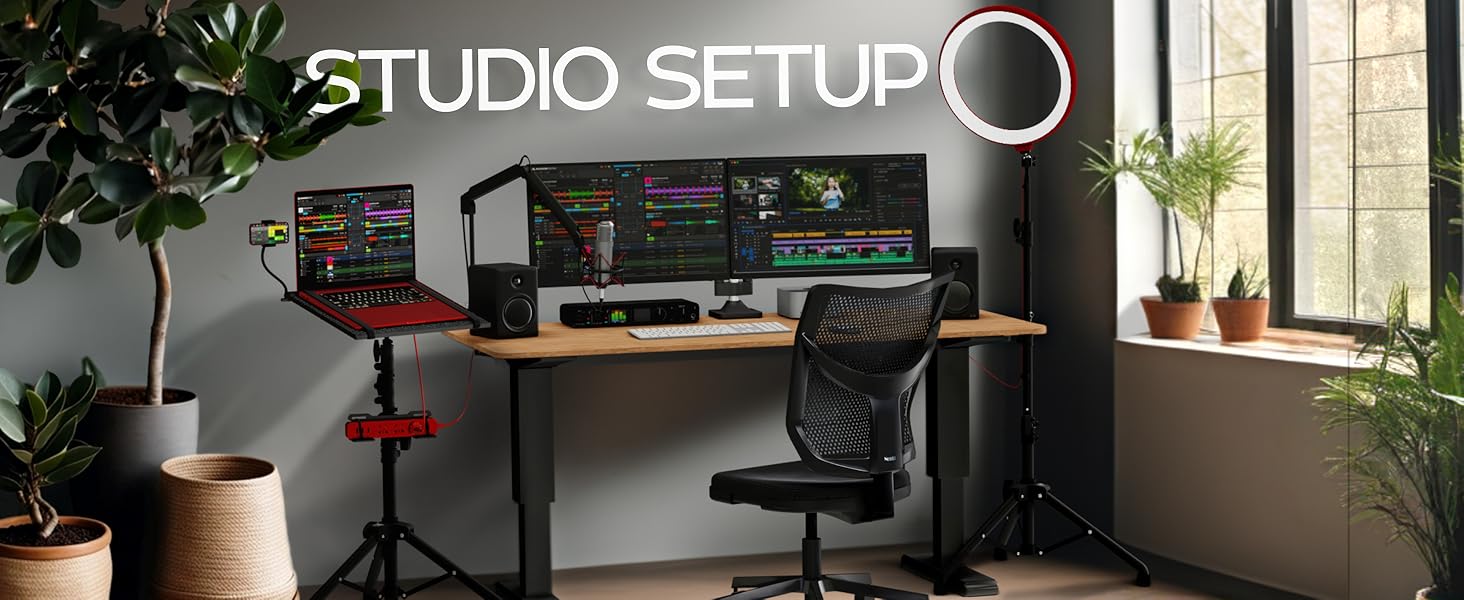 Studio setup featuring minimalist studio with tripod stand setup with laptop, mic, chair and screens