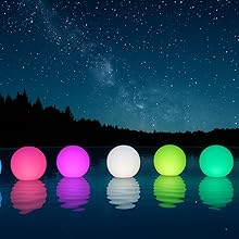 Inflatable solar pool lights glowing under a starry night sky on calm water