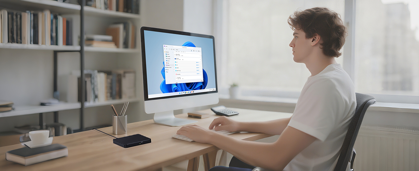 Desktop workspace setup showing computer monitor, keyboard, and mouse on white desk in modern office environment.
