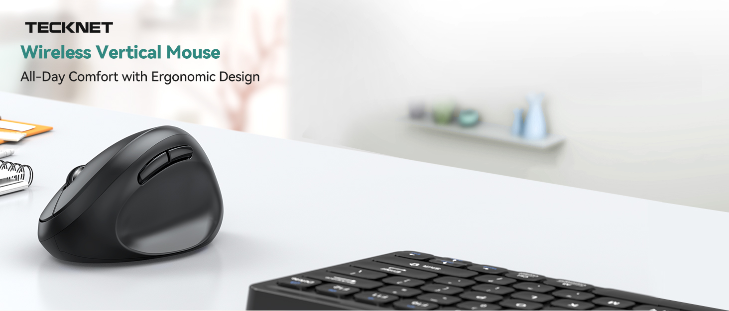 Black wireless vertical mouse next to keyboard on white desk. Product name 'TECKNET Wireless Vertical Mouse' visible, emphasizing ergonomic design for comfort.
