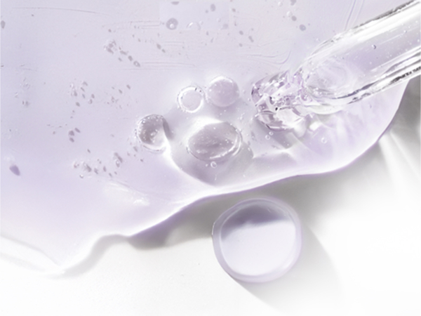 Closeup of dropper &amp; serum particle next to information related to Biotin and its benefits.