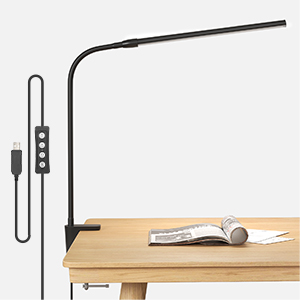 a desk lamp with a book on a desk.