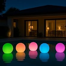 Colorful inflatable solar LED lights floating in a small backyard pool at night