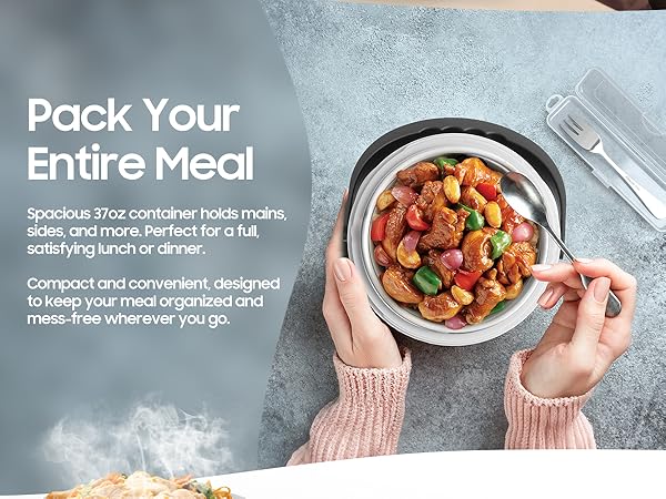 Hands holding heated lunch in electric food warmer with stainless steel container and utensil set