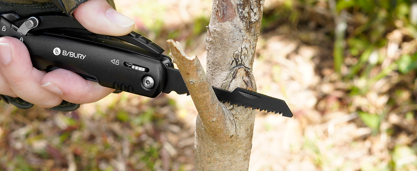 Black pruning tool in use, cutting a tree branch. The compact handheld tool appears to be battery-powered or electric.