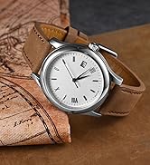 Analog wristwatch with white dial, brown leather strap, and date display, placed on a leather surface with map details visible.