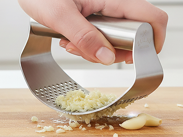 Handheld stainless steel garlic smasher rocker for fast and easy food prep.
