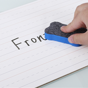 Close-up of child's hand holding blue marker writing 'FROM' on white paper, demonstrating marker functionality and line weight.