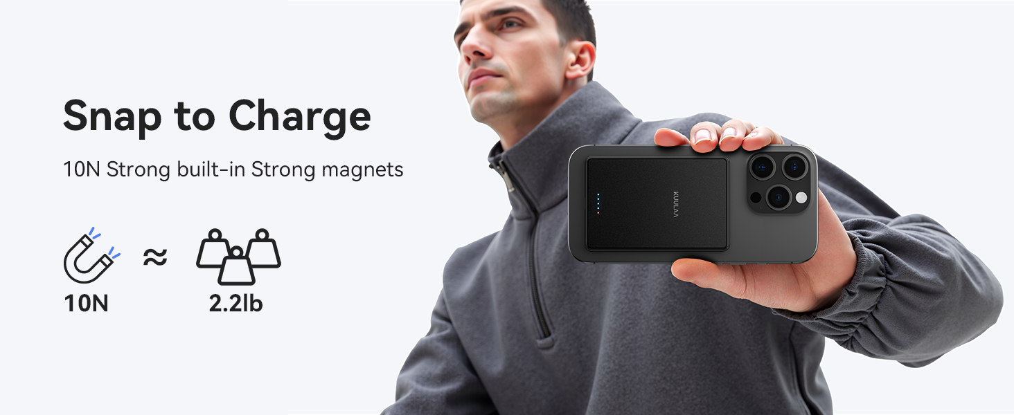 Black magnetic wireless charger for smartphones with 10N strong magnets, weighing 2.2lb. Shown attached to back of phone held by person in gray jacket.