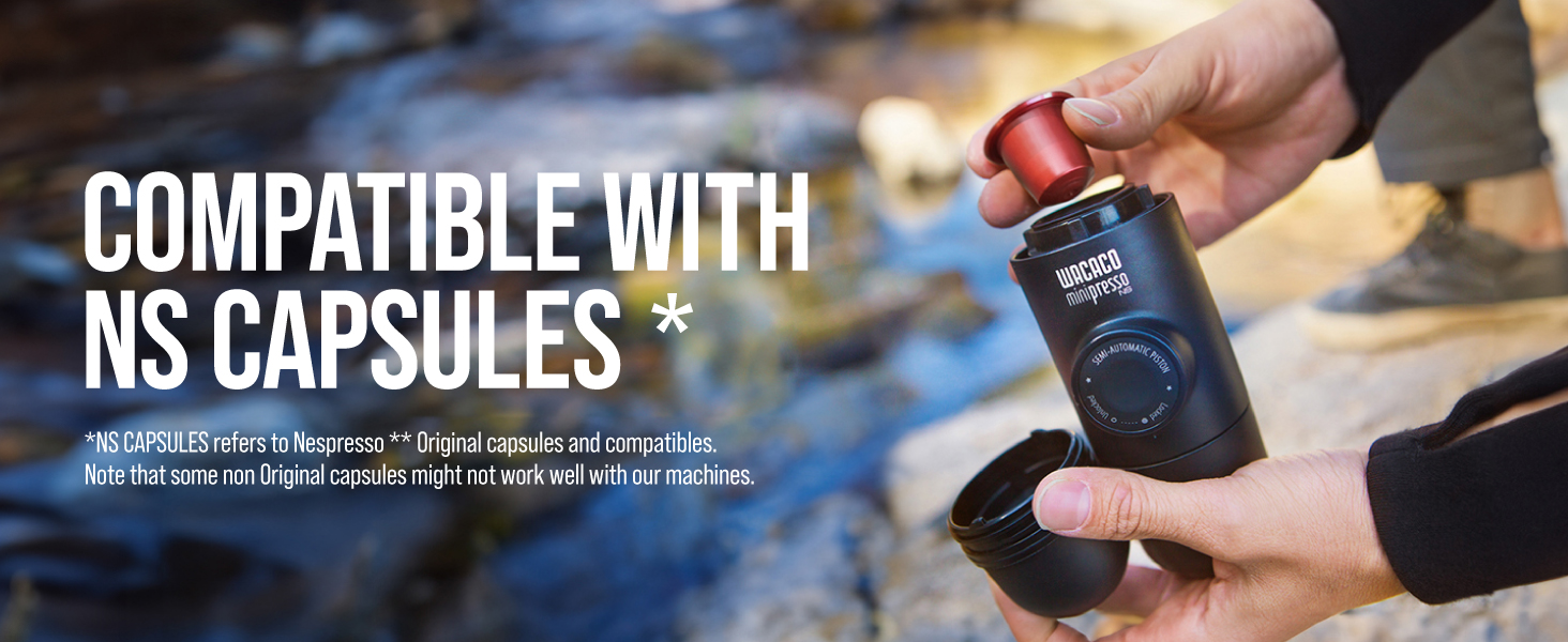 Hands demonstrating a dark-colored container labeled as compatible with NS capsules against an outdoor blurred background.