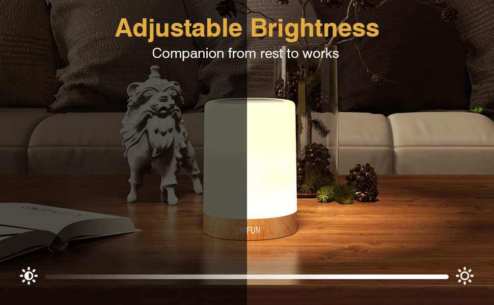Cylindrical table lamp with adjustable brightness control, showing split view of dim and bright settings in a living room environment.