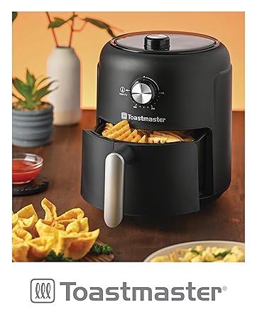 Toastmaster 2.6 quart manual control air fryer with waffle fries on a kitchen countertop