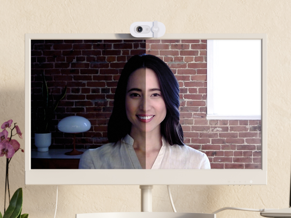 a woman having a video call using brio 100 full hd webcam for meetings and streaming