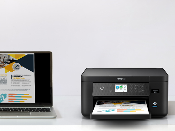 Black Expression Home XP-5200 on desk wirelessly printing content from laptop