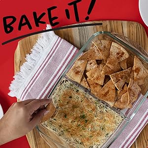 Hand over food in a glass container.