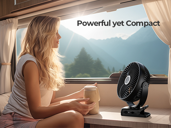 Compact black electric fan in RV interior. Woman sitting nearby holding drink. Text 'Powerful yet Compact' highlights fan's key features.