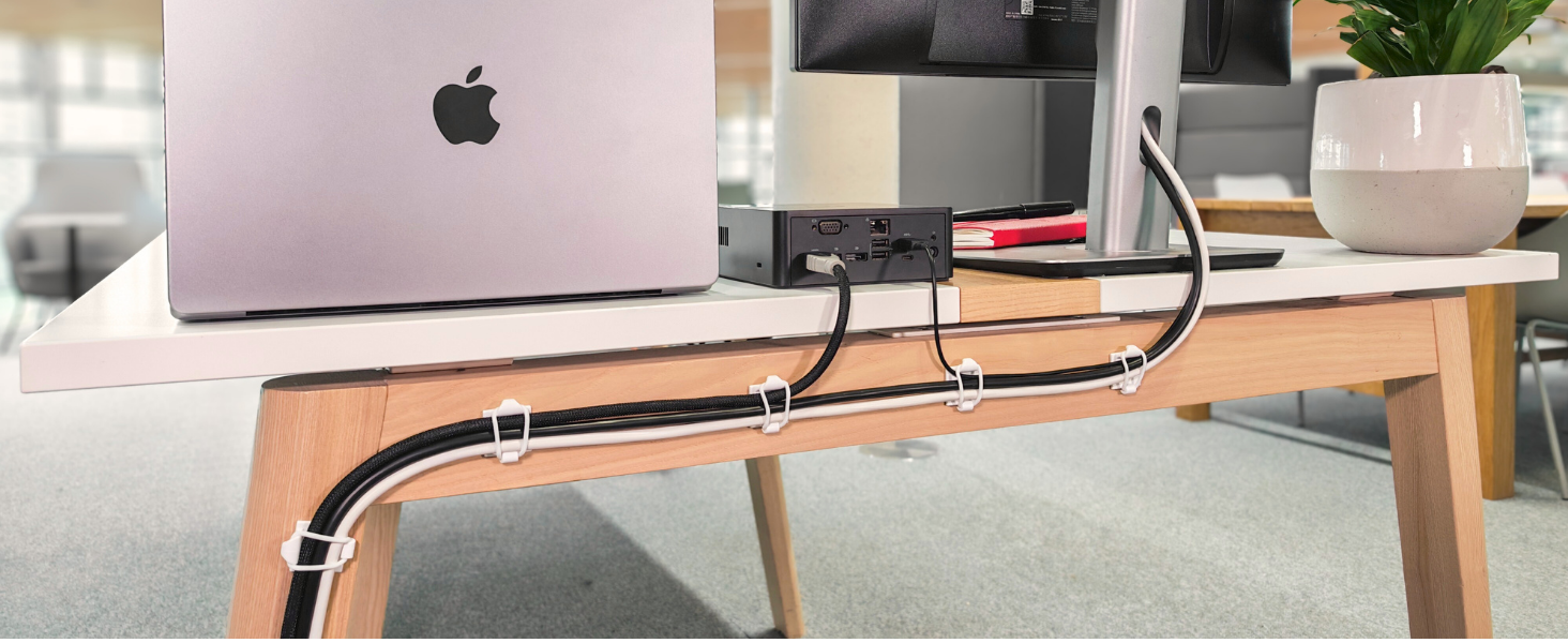 Proudct holding cables behind desk.