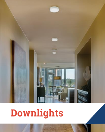 Contemporary hallway with recessed LED downlights illuminating artwork and furniture.