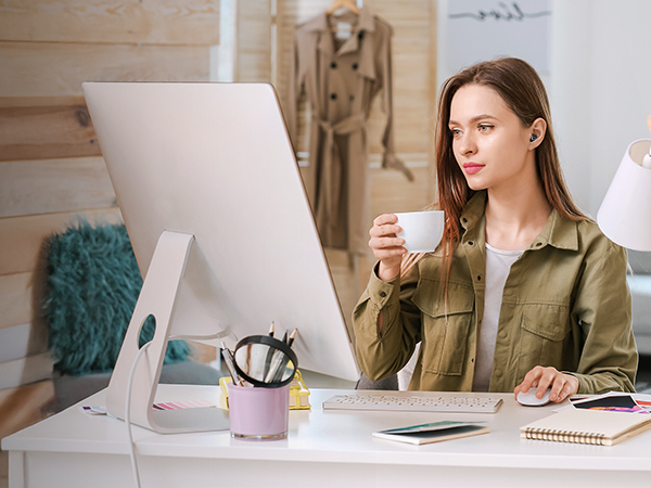 Series of images showing person working at desk with laptop and monitor setup in bright, modern office environment. Focus on ergonomic workspace arrangement.