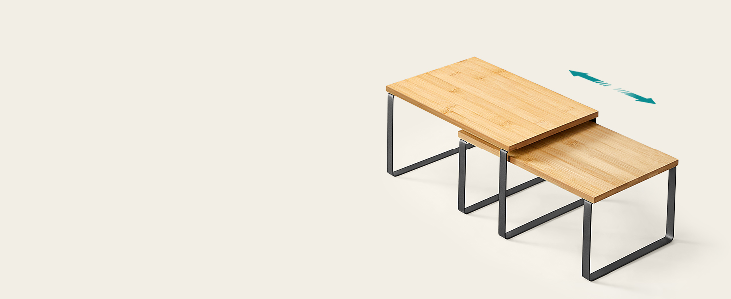 Two-tiered nesting coffee tables with light wood tops and gray metal frames. The smaller table slides under the larger one for space-saving functionality.