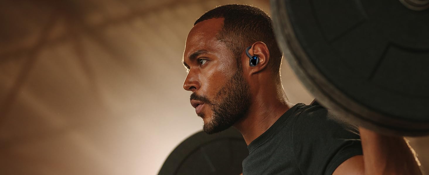 a man wearing a bluetooth headset in the gym