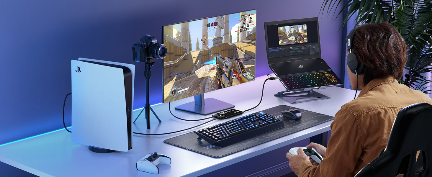 a man playing a video game on a laptop