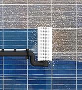 Aerial view of solar panels being cleaned with a long-handled brush roller system, showing contrast between clean and dirty sections of the panels.