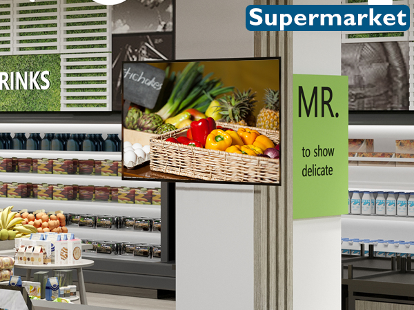 Supermarket interior with shelves of products, produce display featuring fresh fruits and vegetables, and signage for different sections including drinks and delicatessen.