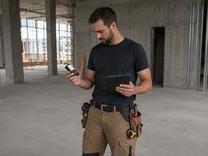 COROLLATA bilateral laser distance meter used by contractor measuring empty floor alone