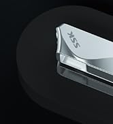 Close-up partial view of what appears to be a metallic or silver-colored mechanical device against a dark background.