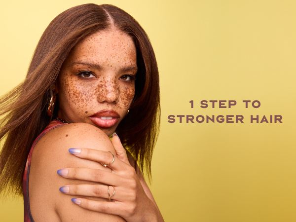 Image of a black woman with freckles &amp; straight hair next to text: "1 step to stronger hair".
