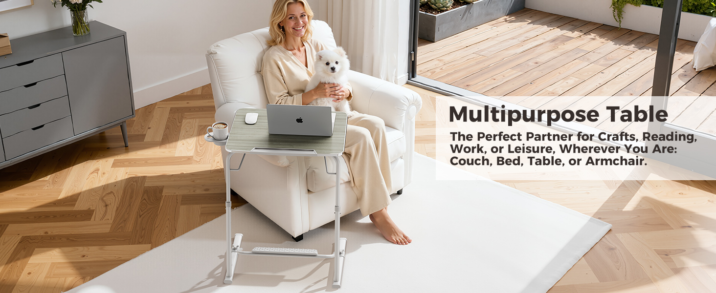 Woman using foldable laptop table as an armchair table while relaxing with her dog.