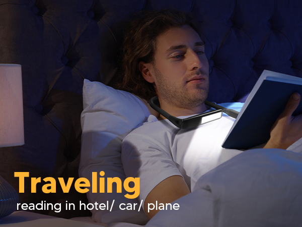 A young man is enjoying reading book in bed in the hotel room with the EastPin LED neck book light