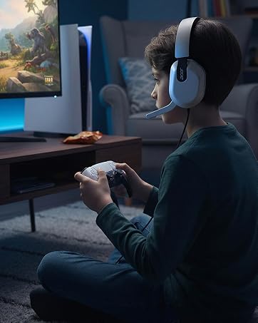 Gamer adjusting physical volume wheel and Bluetooth to 2.4G slider switch on left earcup blindly