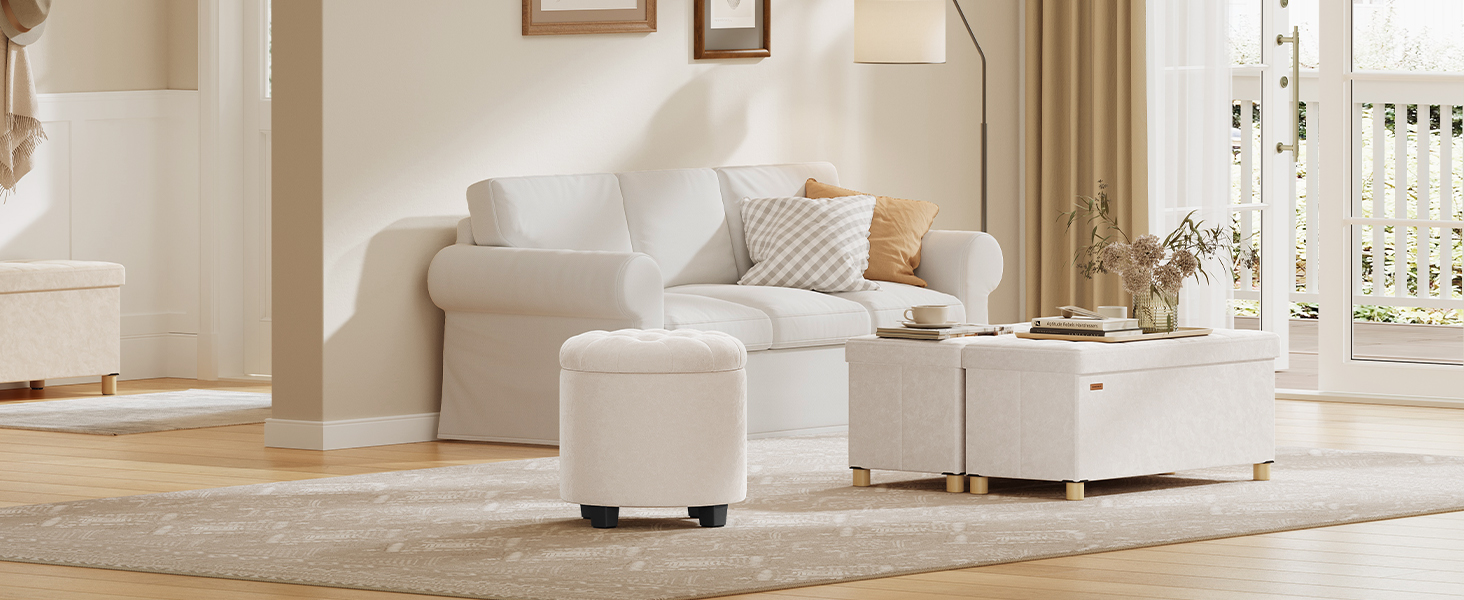 Modern living room interior featuring white furniture set including sofa and ottoman, with neutral tones and elegant decor.