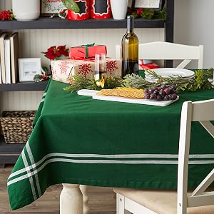A Christmas table scene, with DII French Stripe tablecloth in green