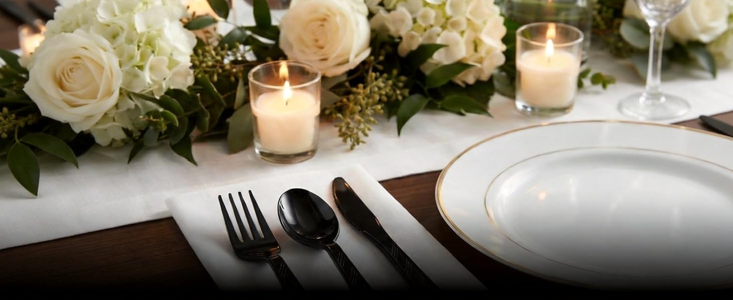 On a table lay exquisite tableware and black plastic cutlery