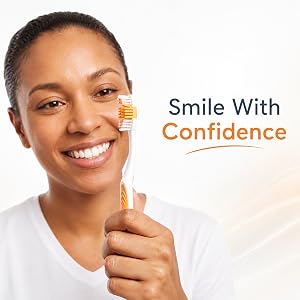 Woman smiling with an Ora-Zen Toothbrush