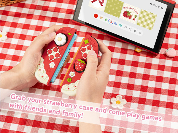 Text reads 'Grab your strawberry case and come play games with friends and family!' Product images on red and white checkered tablecloth showing gaming device case.