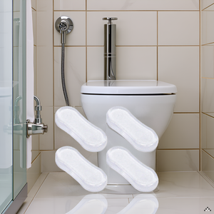 A bathroom counter with a vase of flowers and a rolled-up towel next to the product.