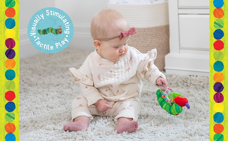 baby with ring rattle