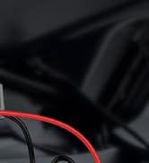 a red and black wire connected to a car