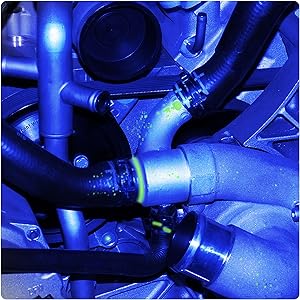 a close up of a blue engine with a black tube